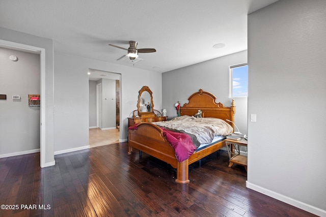 bedroom with hardwood / wood-style floors, a ceiling fan, and baseboards