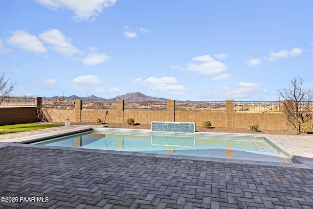 view of pool featuring a mountain view, a fenced backyard, and a fenced in pool