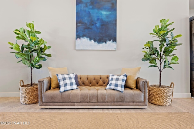 living room featuring wood finished floors and baseboards