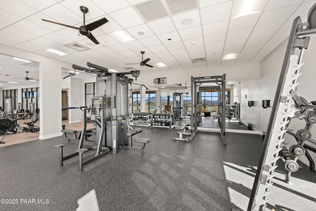 gym featuring visible vents, a drop ceiling, and a ceiling fan