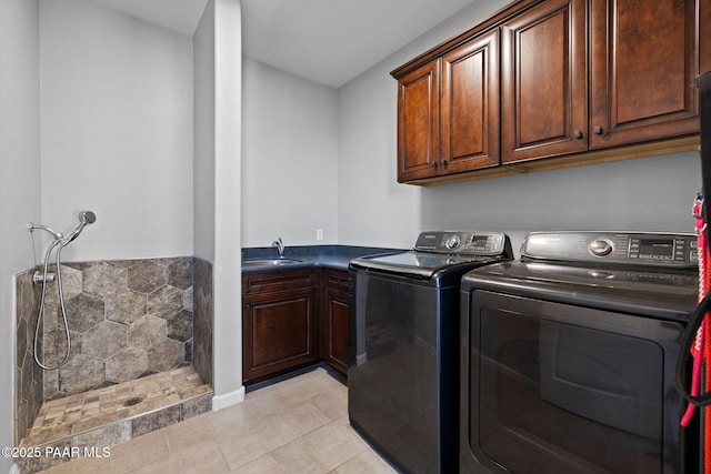 clothes washing area featuring washer and dryer, cabinet space, a sink, and light tile patterned flooring