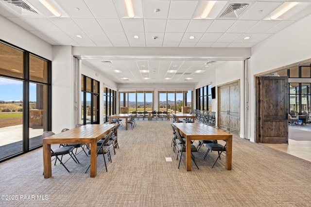 carpeted dining space featuring a paneled ceiling, visible vents, and recessed lighting