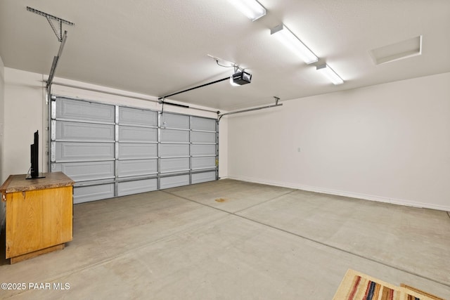 7912 Huckleberry Trl, Prescott Valley, AZ 86315 - garage featuring a garage door opener and baseboards