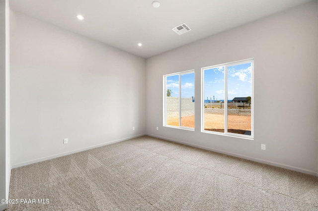 spare room with light carpet, baseboards, visible vents, and recessed lighting