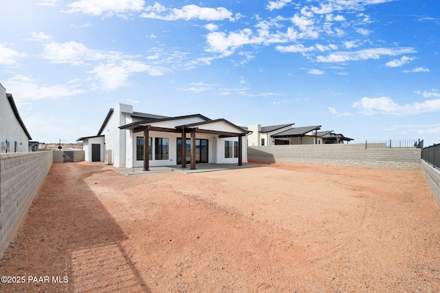 rear view of property with a patio and a fenced backyard