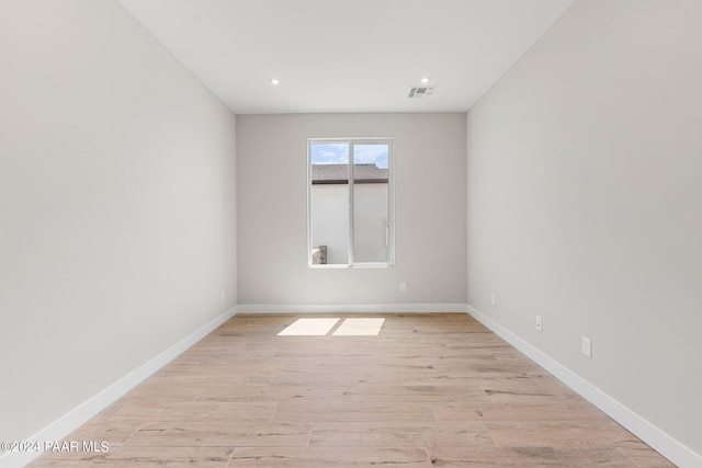 spare room featuring light hardwood / wood-style flooring