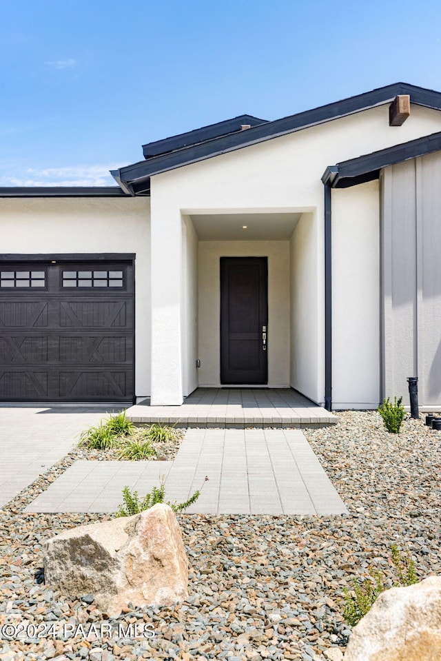 doorway to property with a garage