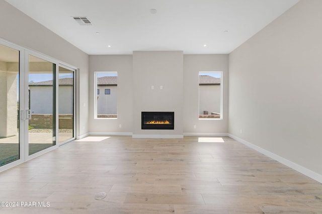 unfurnished living room with light hardwood / wood-style flooring