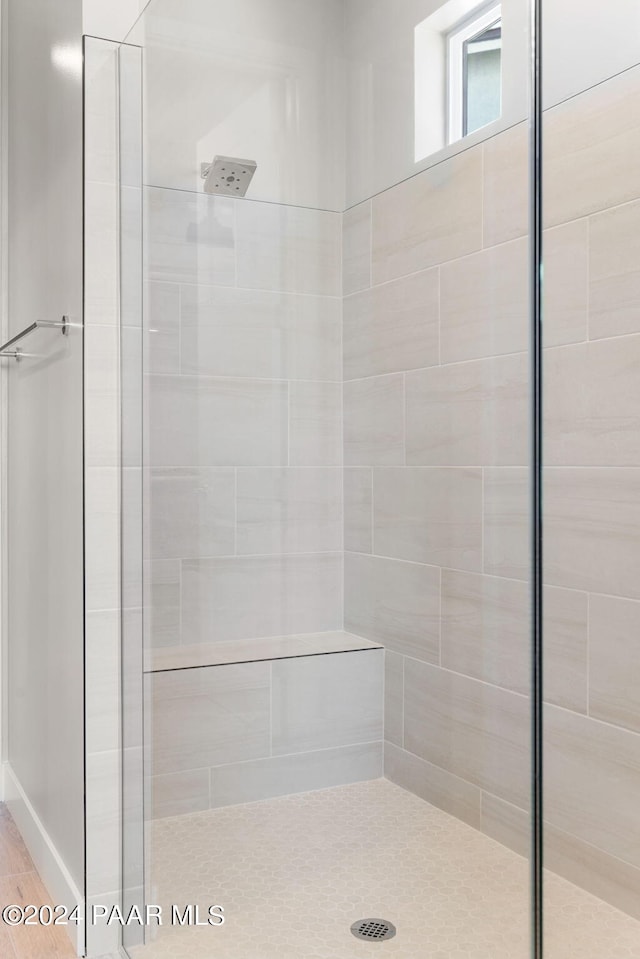 bathroom with tiled shower