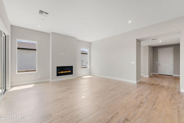 unfurnished living room featuring light hardwood / wood-style floors