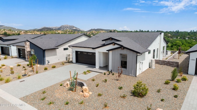 modern inspired farmhouse with a mountain view and a garage