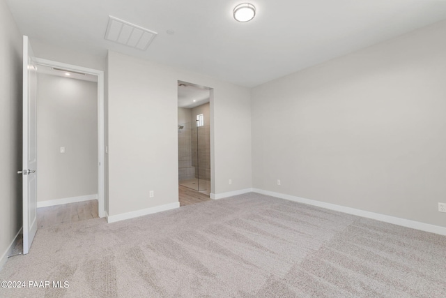 unfurnished bedroom featuring light carpet