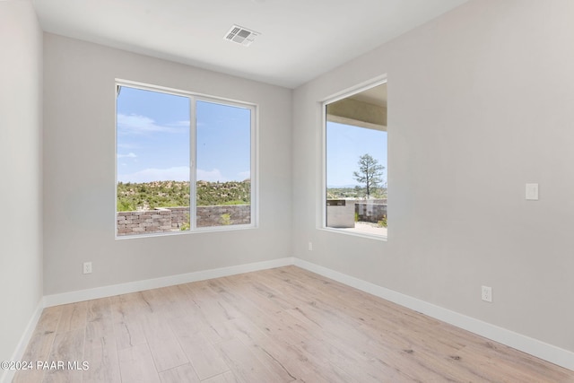 spare room with light hardwood / wood-style floors