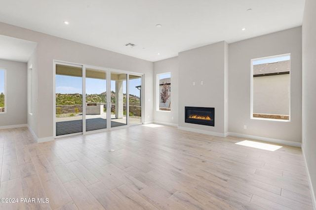 unfurnished living room featuring light wood-type flooring