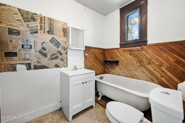 234 N Arizona Ave, Prescott, AZ 86301 - bathroom with toilet, a freestanding bath, wooden walls, vanity, and wainscoting