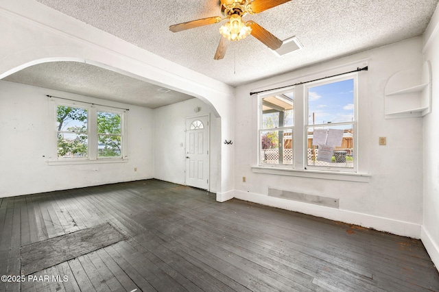 234 N Arizona Ave, Prescott, AZ 86301 - unfurnished room featuring a textured ceiling, arched walkways, dark wood-type flooring, ceiling fan, and baseboards