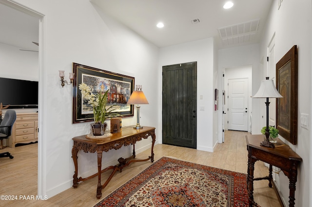 hallway with light hardwood / wood-style flooring