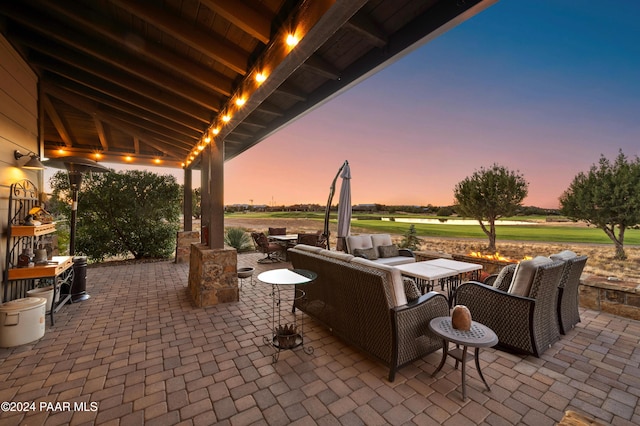 patio terrace at dusk featuring outdoor lounge area