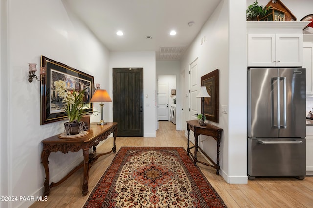 corridor with light hardwood / wood-style flooring