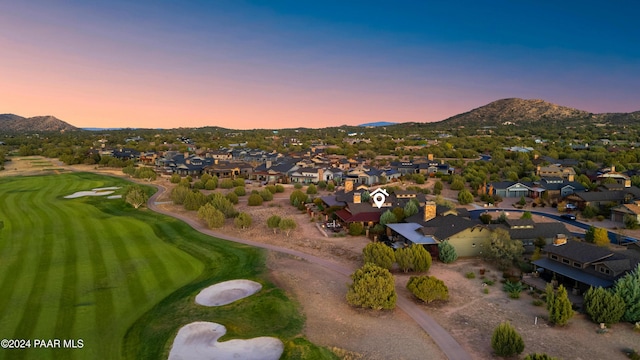 aerial view at dusk featuring a mountain view