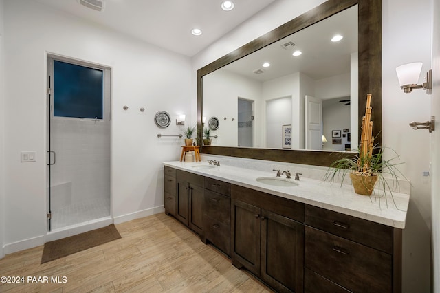 bathroom featuring vanity, a shower with shower door, and hardwood / wood-style flooring