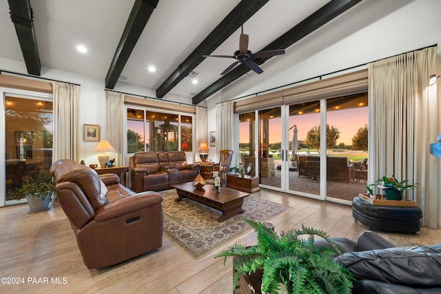 living room featuring lofted ceiling with beams, ceiling fan, and light hardwood / wood-style flooring