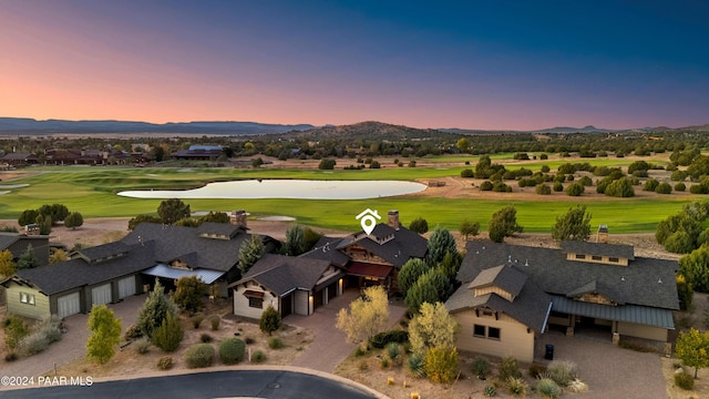 aerial view at dusk featuring a mountain view