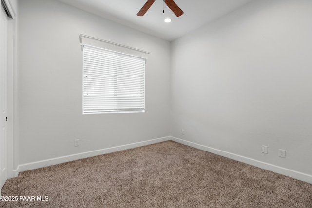 unfurnished room featuring ceiling fan and carpet flooring