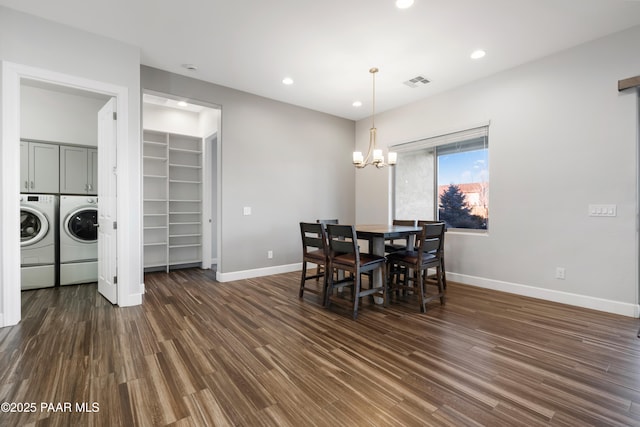 dining space with an inviting chandelier, dark wood-type flooring, and independent washer and dryer