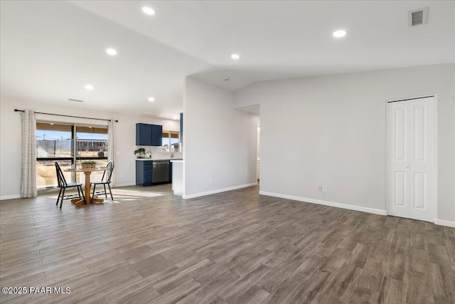 living room featuring hardwood / wood-style floors and lofted ceiling