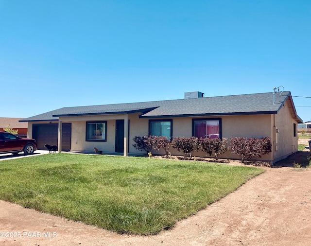 single story home with a front yard and a garage