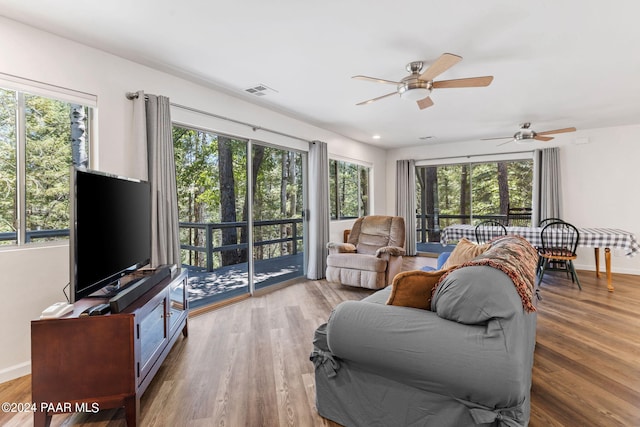 living room featuring hardwood / wood-style flooring, plenty of natural light, and ceiling fan