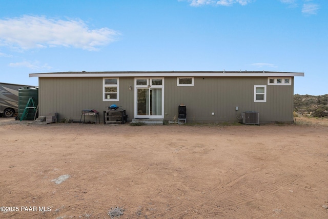 back of house featuring cooling unit