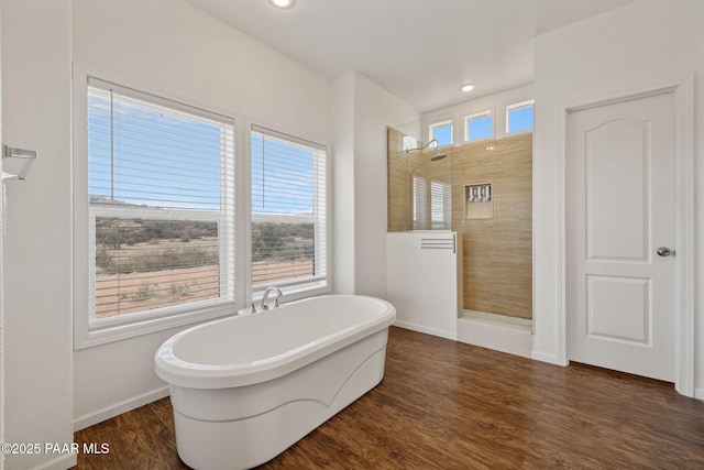 full bath with baseboards, a freestanding tub, wood finished floors, and a walk in shower