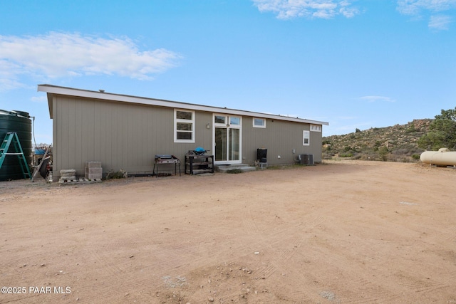 rear view of property with central air condition unit