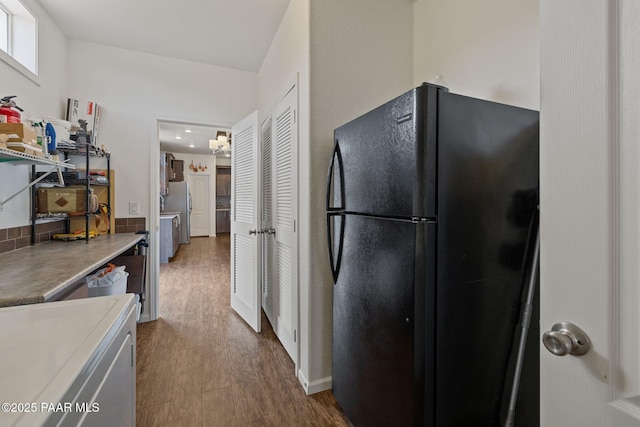 kitchen with freestanding refrigerator and dark wood-style floors