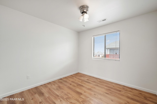 empty room featuring ceiling fan and light hardwood / wood-style flooring