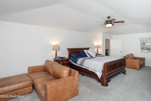 carpeted bedroom featuring vaulted ceiling and ceiling fan