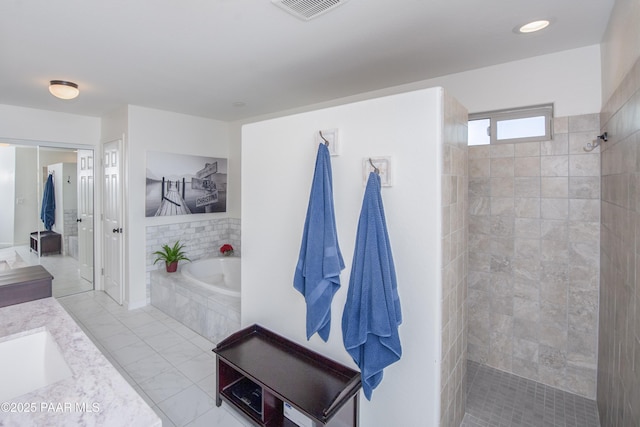 bathroom featuring vanity and separate shower and tub