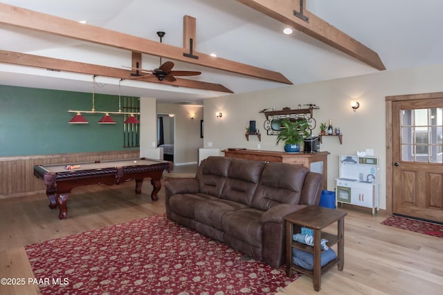 living room with ceiling fan, billiards, light hardwood / wood-style flooring, and vaulted ceiling with beams