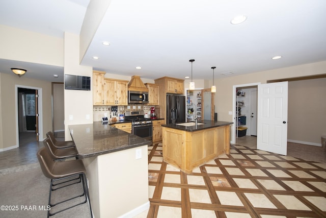 kitchen with hanging light fixtures, stainless steel appliances, kitchen peninsula, and a kitchen bar