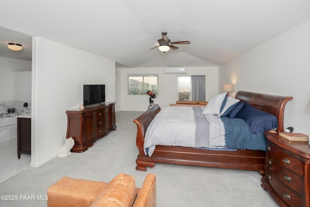 bedroom with lofted ceiling, ensuite bathroom, light carpet, an AC wall unit, and ceiling fan