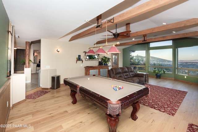 game room with billiards, beamed ceiling, ceiling fan, light hardwood / wood-style floors, and a mountain view