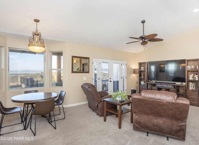 living room featuring lofted ceiling, light colored carpet, and ceiling fan