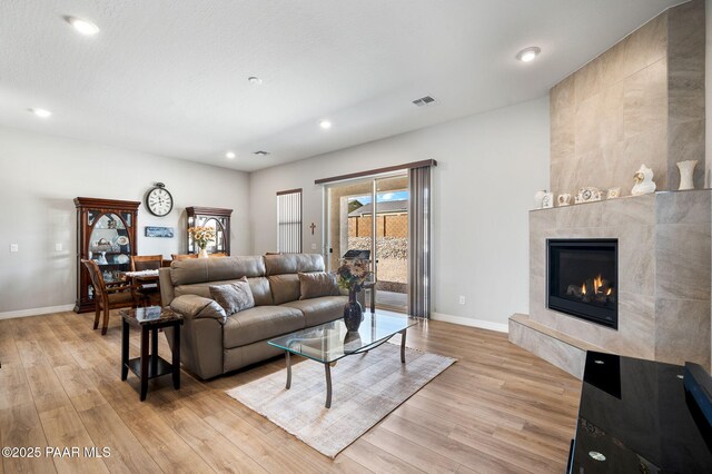 6166 E Shetland Way, Prescott Valley, AZ 86314 - living room with light wood-style flooring, baseboards, recessed lighting, and a fireplace