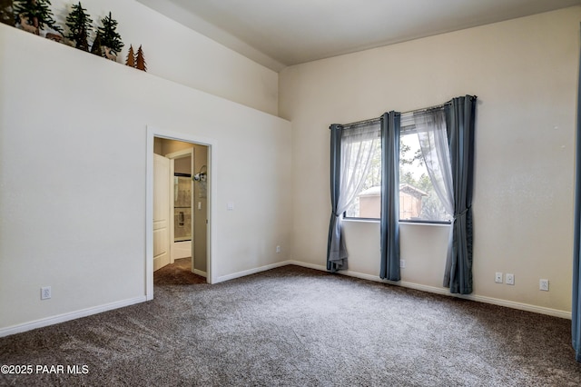 carpeted empty room with baseboards