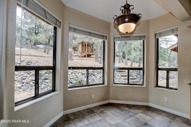 unfurnished room with baseboards and vaulted ceiling