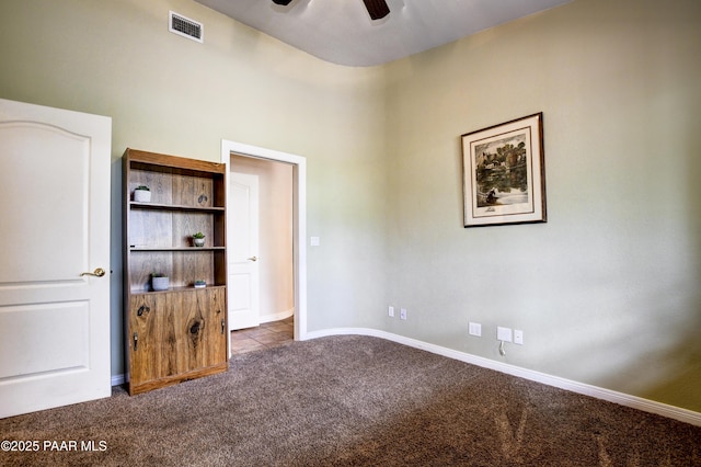 unfurnished bedroom featuring visible vents, baseboards, ceiling fan, and carpet flooring