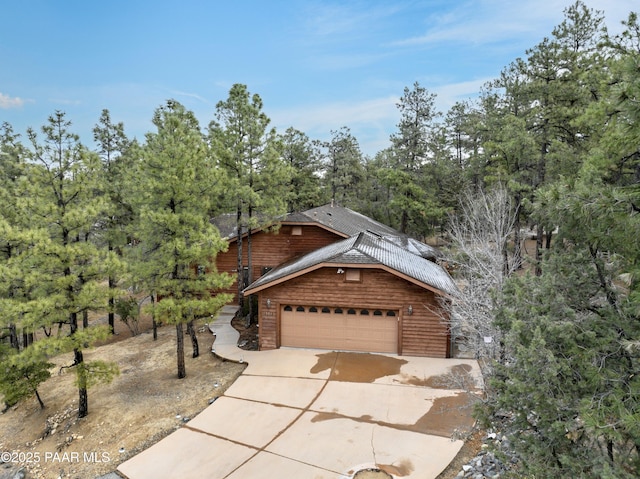 view of front of property with an attached garage and concrete driveway