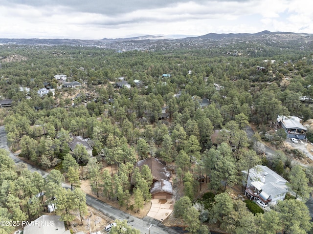 birds eye view of property featuring a mountain view and a wooded view